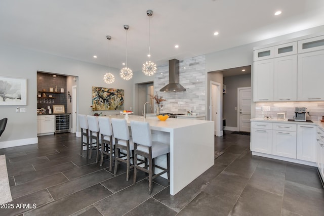 4331 N 19th Pl, Phoenix, AZ 85016 - kitchen with wall chimney range hood, light countertops, beverage cooler, and backsplash