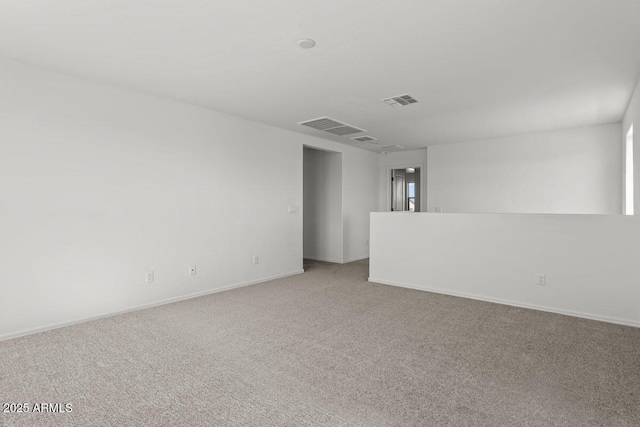 unfurnished room with baseboards, visible vents, and carpet flooring