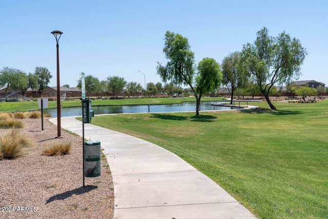 view of community featuring a water view and a yard