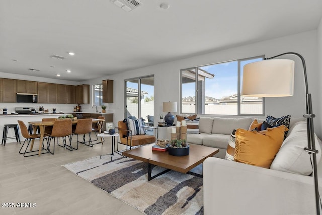 living room with recessed lighting and visible vents