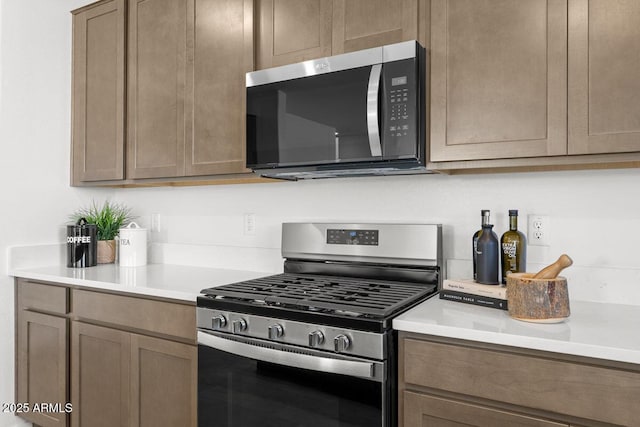 kitchen with appliances with stainless steel finishes and light countertops