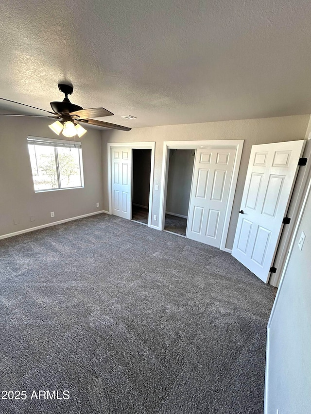 unfurnished bedroom featuring a textured ceiling, ceiling fan, and dark carpet