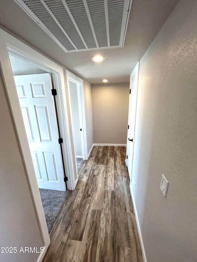 hallway with dark hardwood / wood-style floors