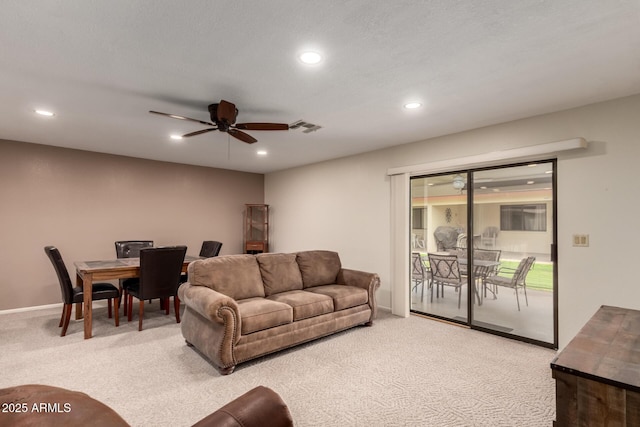 living area featuring recessed lighting, a ceiling fan, light colored carpet, and visible vents
