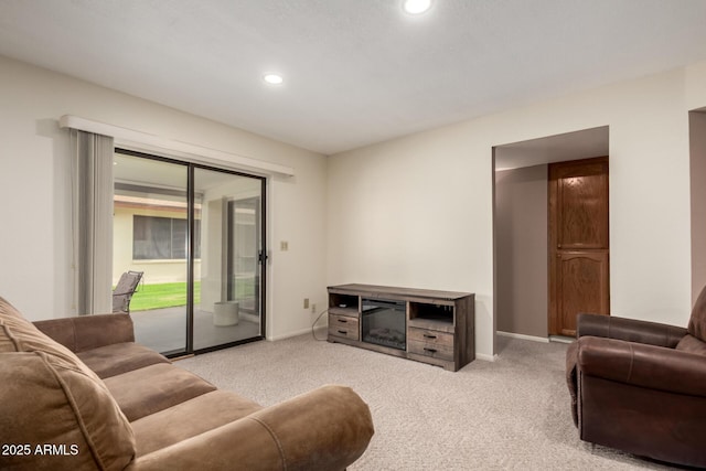 carpeted living area featuring recessed lighting and baseboards