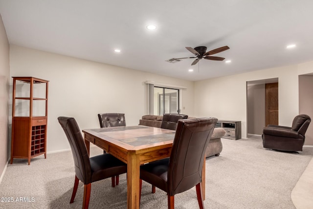 dining room featuring baseboards, light carpet, a ceiling fan, and recessed lighting