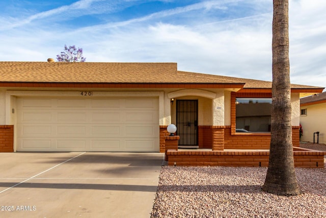 ranch-style house with roof with shingles, driveway, and a garage