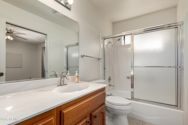 full bathroom with vanity, toilet, bath / shower combo with glass door, tile patterned floors, and a ceiling fan