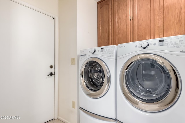 laundry room featuring independent washer and dryer and cabinet space