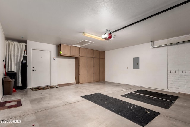 garage with a garage door opener and electric panel
