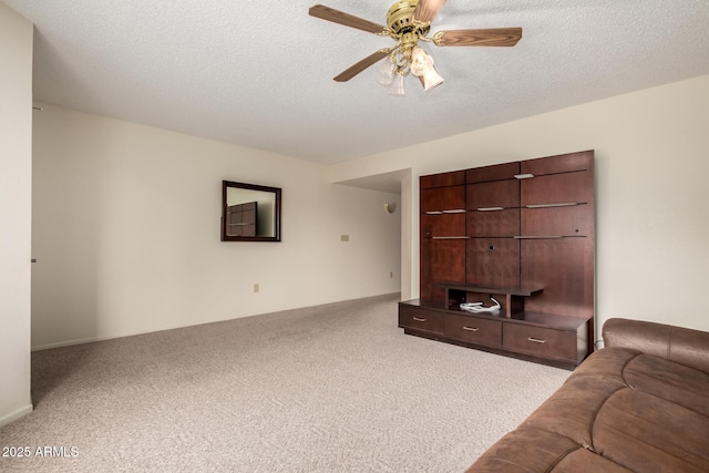carpeted living area with a ceiling fan and a textured ceiling