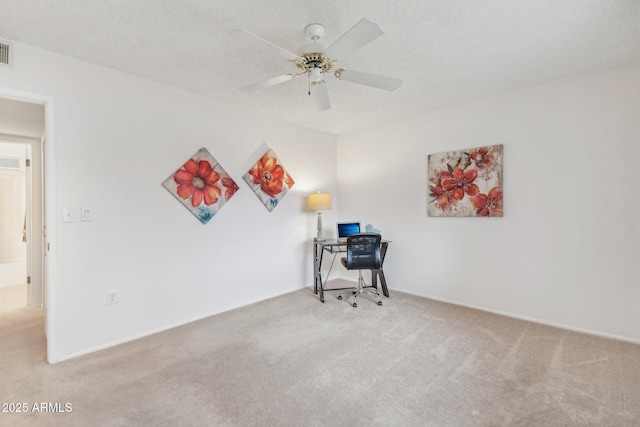 office area with ceiling fan, light carpet, and a textured ceiling