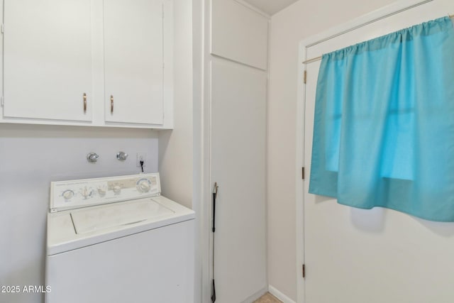 laundry room featuring cabinets and washer / clothes dryer