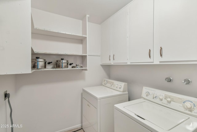 laundry room featuring separate washer and dryer and cabinets