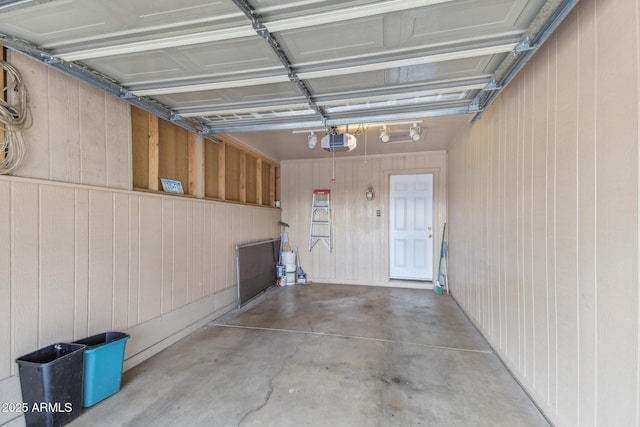 garage with a garage door opener and wood walls