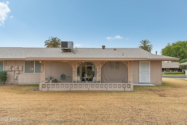 single story home with central air condition unit and a front lawn