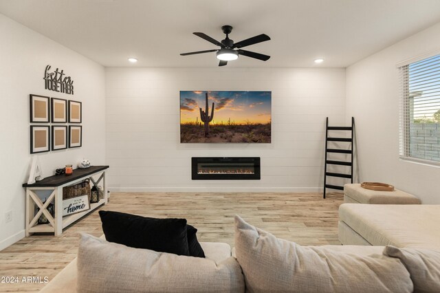 16848 W Alice Ave, Waddell, AZ 85355 - living room featuring wood finished floors, baseboards, a glass covered fireplace, a ceiling fan, and recessed lighting