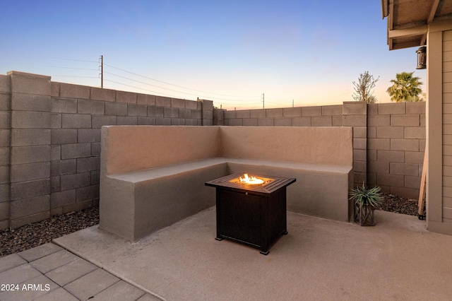 16848 W Alice Ave, Waddell, AZ 85355 - patio terrace at dusk with a fire pit and a fenced backyard