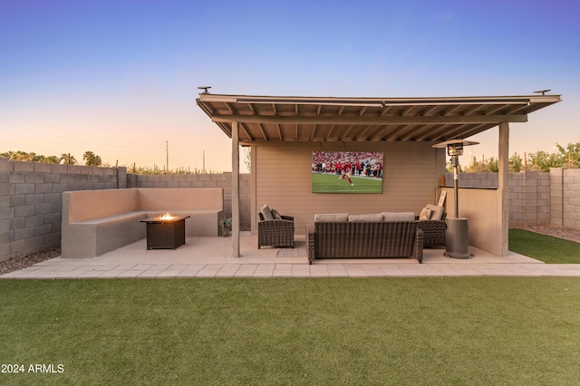 16848 W Alice Ave, Waddell, AZ 85355 - patio terrace at dusk with an outdoor living space with a fire pit