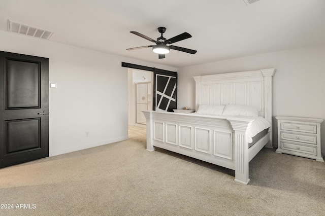 16848 W Alice Ave, Waddell, AZ 85355 - carpeted bedroom featuring a barn door, baseboards, and a ceiling fan