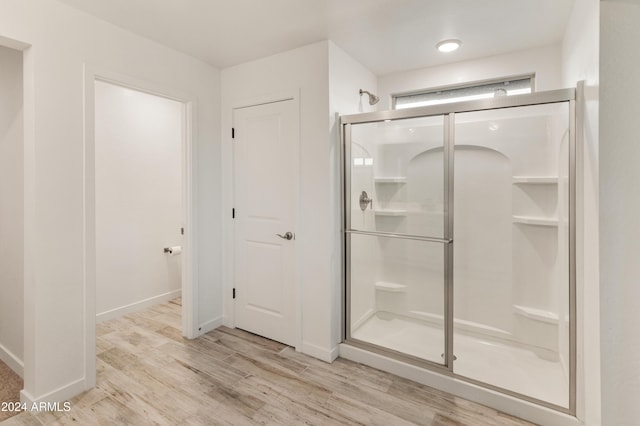 16848 W Alice Ave, Waddell, AZ 85355 - bathroom featuring a stall shower, wood finished floors, and baseboards