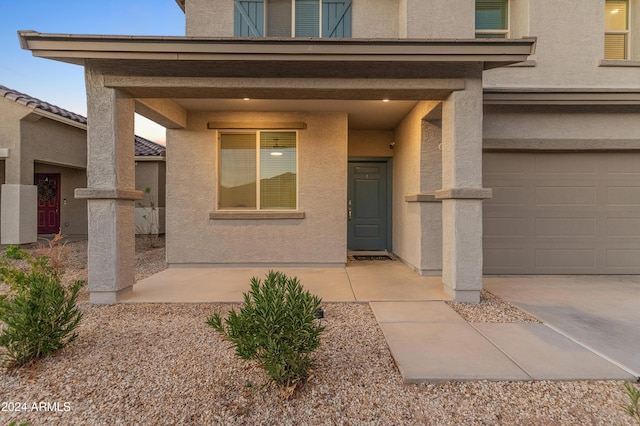 16848 W Alice Ave, Waddell, AZ 85355 - doorway to property with stucco siding and a garage