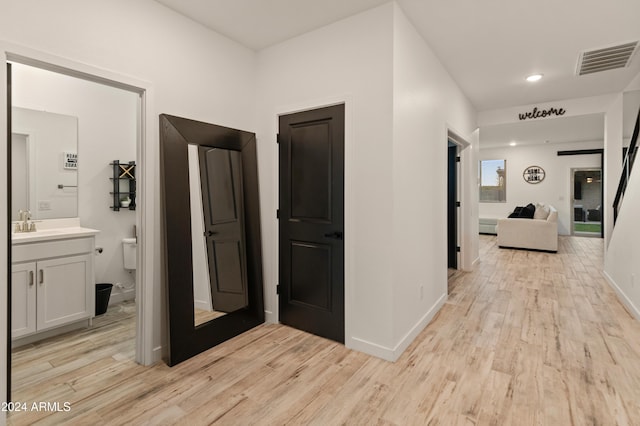 16848 W Alice Ave, Waddell, AZ 85355 - corridor with light wood-style flooring, a sink, baseboards, and recessed lighting
