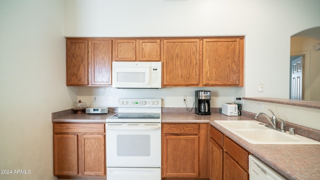 kitchen with sink and white appliances