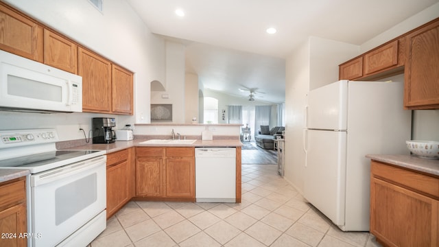 kitchen featuring light tile patterned floors, sink, white appliances, lofted ceiling, and ceiling fan