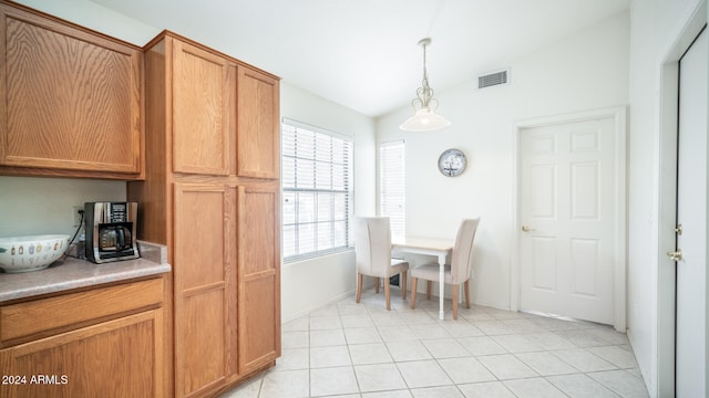 tiled dining room with vaulted ceiling