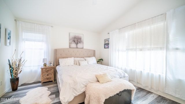 bedroom featuring lofted ceiling and dark hardwood / wood-style floors