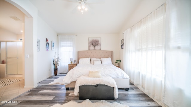 bedroom featuring connected bathroom, ceiling fan, and dark hardwood / wood-style floors