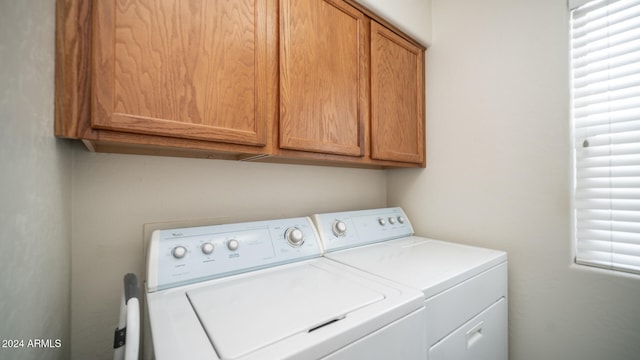 laundry area with cabinets and washing machine and clothes dryer