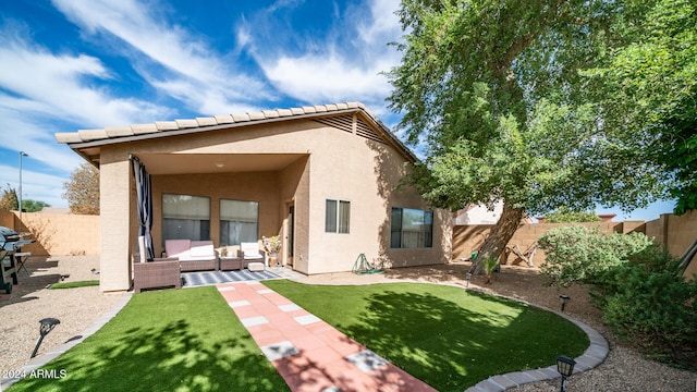 back of property featuring outdoor lounge area and a patio area