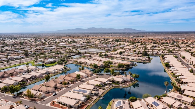 birds eye view of property with a water and mountain view