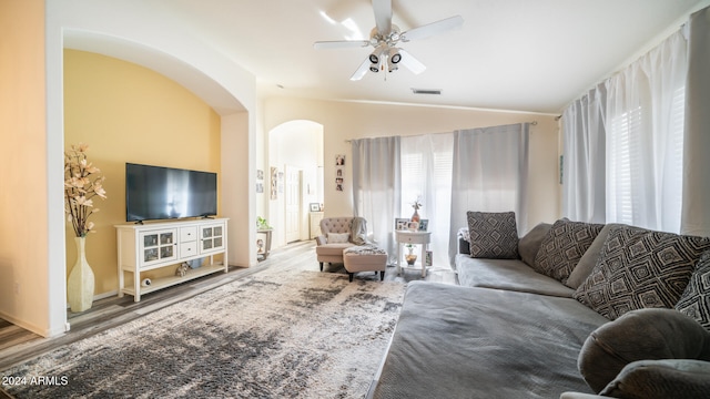 living room featuring vaulted ceiling, ceiling fan, and wood-type flooring