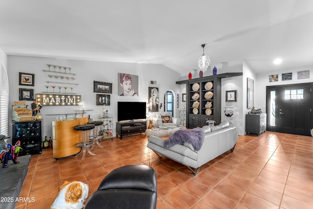 tiled living room with bar and vaulted ceiling