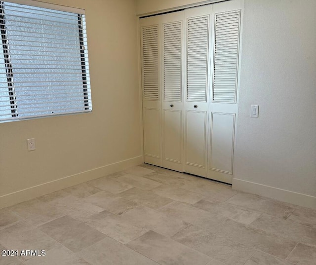 unfurnished bedroom with a closet