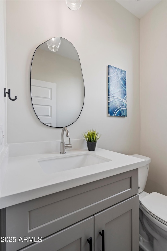 bathroom featuring toilet and vanity