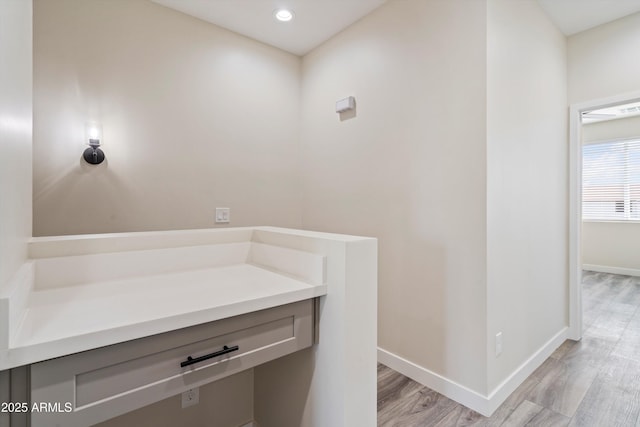 bathroom featuring baseboards, recessed lighting, and wood finished floors