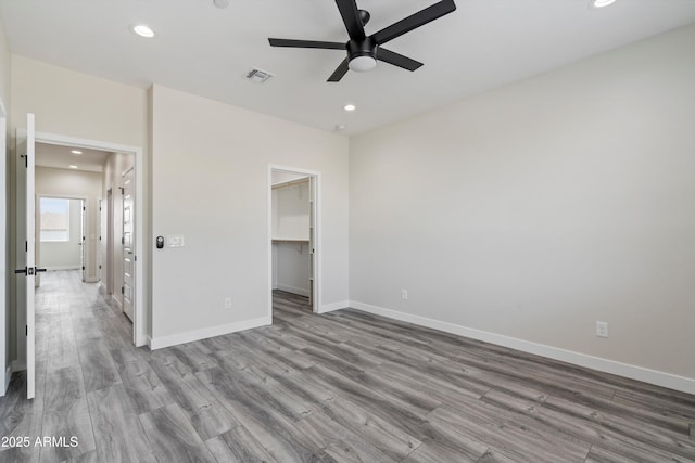 unfurnished bedroom featuring recessed lighting, wood finished floors, and visible vents