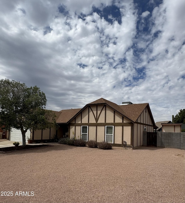 12512 N 85th Ave, Peoria, AZ 85381 - english style home featuring stucco siding, a garage, and roof with shingles