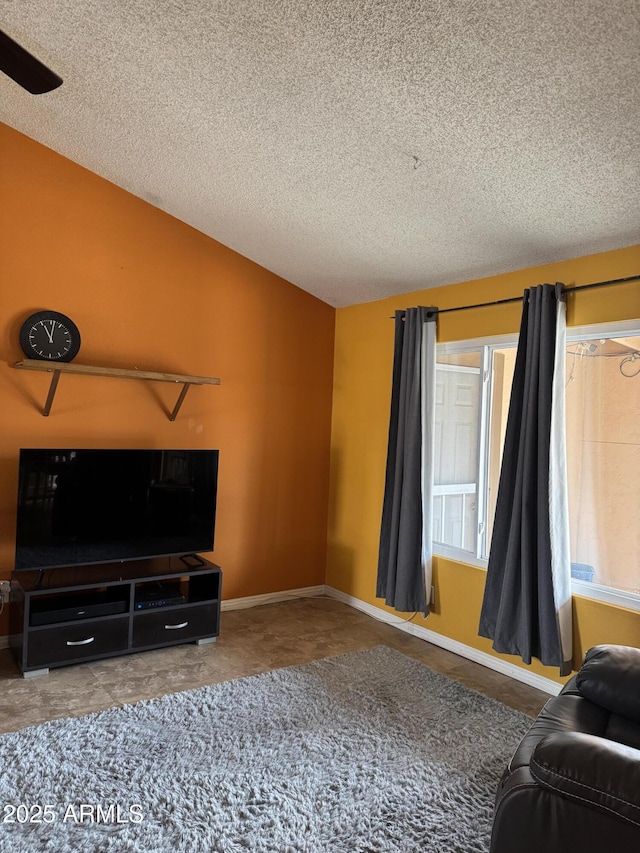 12512 N 85th Ave, Peoria, AZ 85381 - living area with a textured ceiling, vaulted ceiling, ceiling fan, and baseboards