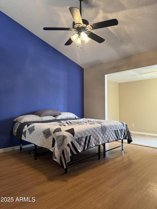 12512 N 85th Ave, Peoria, AZ 85381 - bedroom with a textured ceiling, baseboards, wood finished floors, ceiling fan, and lofted ceiling