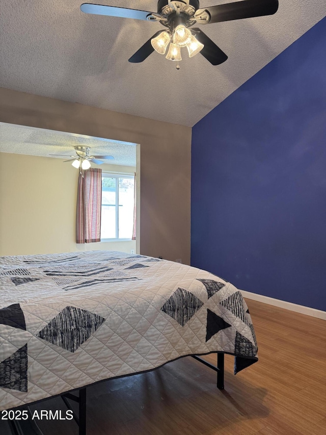 12512 N 85th Ave, Peoria, AZ 85381 - bedroom with wood finished floors, a textured ceiling, a ceiling fan, and baseboards