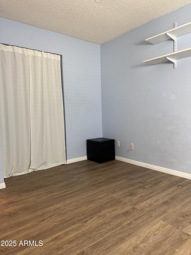 12512 N 85th Ave, Peoria, AZ 85381 - empty room with wood finished floors, baseboards, and a textured ceiling