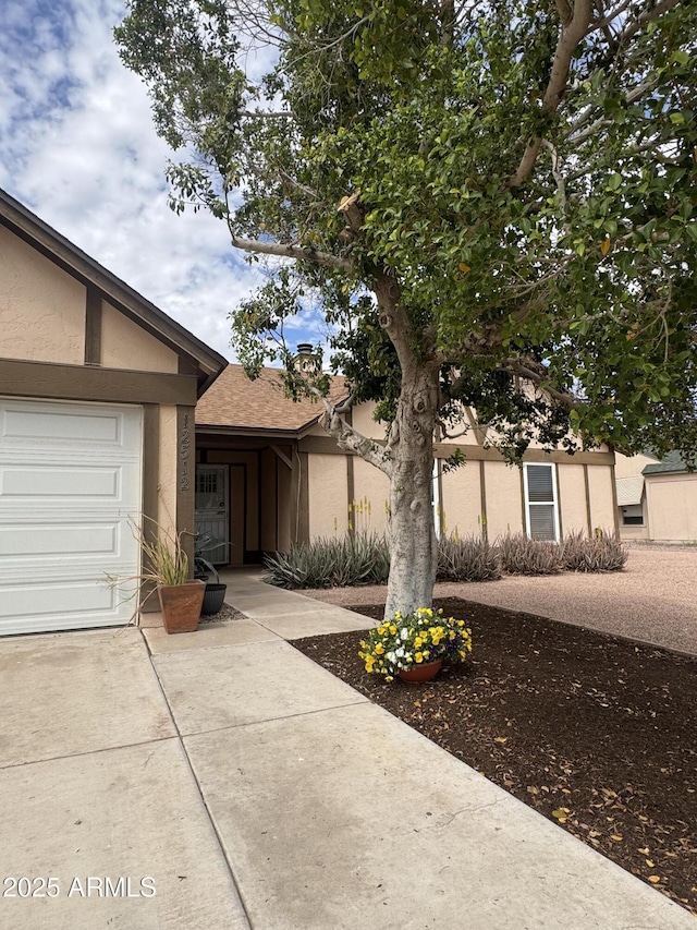 12512 N 85th Ave, Peoria, AZ 85381 - view of front of house featuring stucco siding, driveway, and an attached garage