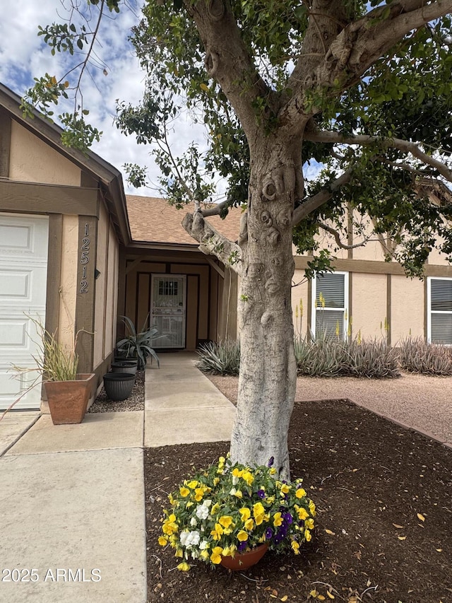 12512 N 85th Ave, Peoria, AZ 85381 - view of home's exterior with stucco siding and roof with shingles
