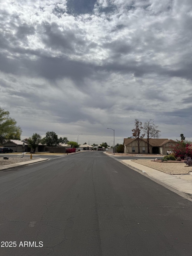 12512 N 85th Ave, Peoria, AZ 85381 - view of asphalt road with street lighting, curbs, and sidewalks