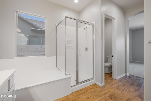 full bathroom featuring vanity, independent shower and bath, toilet, and hardwood / wood-style flooring